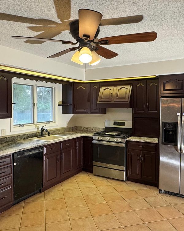 Kitchen after cabinet painting in a deep espresso finish
