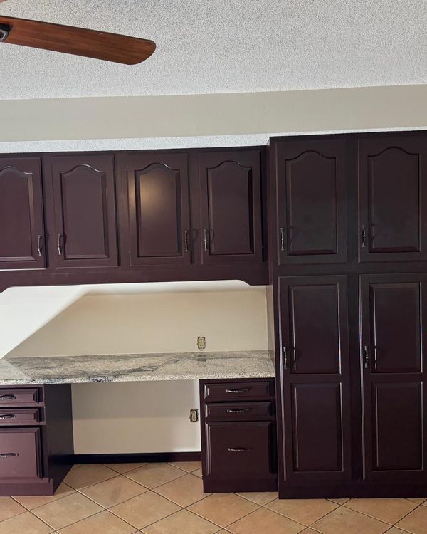 Kitchen desk and tall cabinets after painting in a deep espresso finish