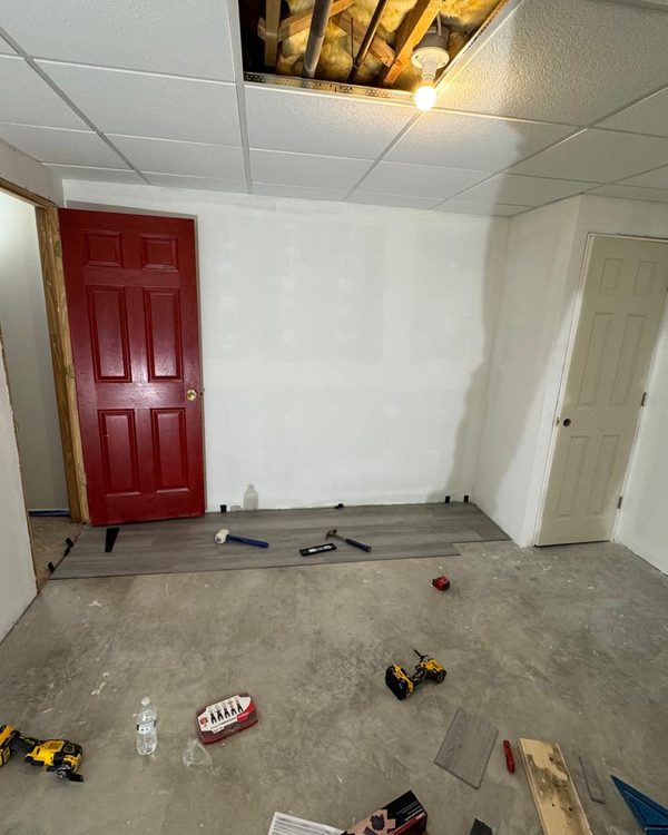 Finished basement room with smooth white walls and new doors