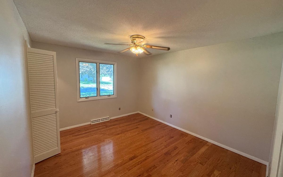 Bedroom with freshly painted neutral walls and white trim