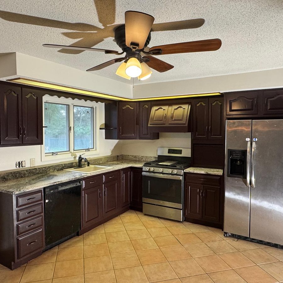 Kitchen after cabinet painting in a deep espresso finish