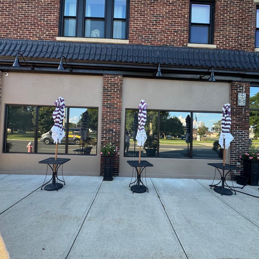 Brick storefront after exterior repaint of the stucco panels