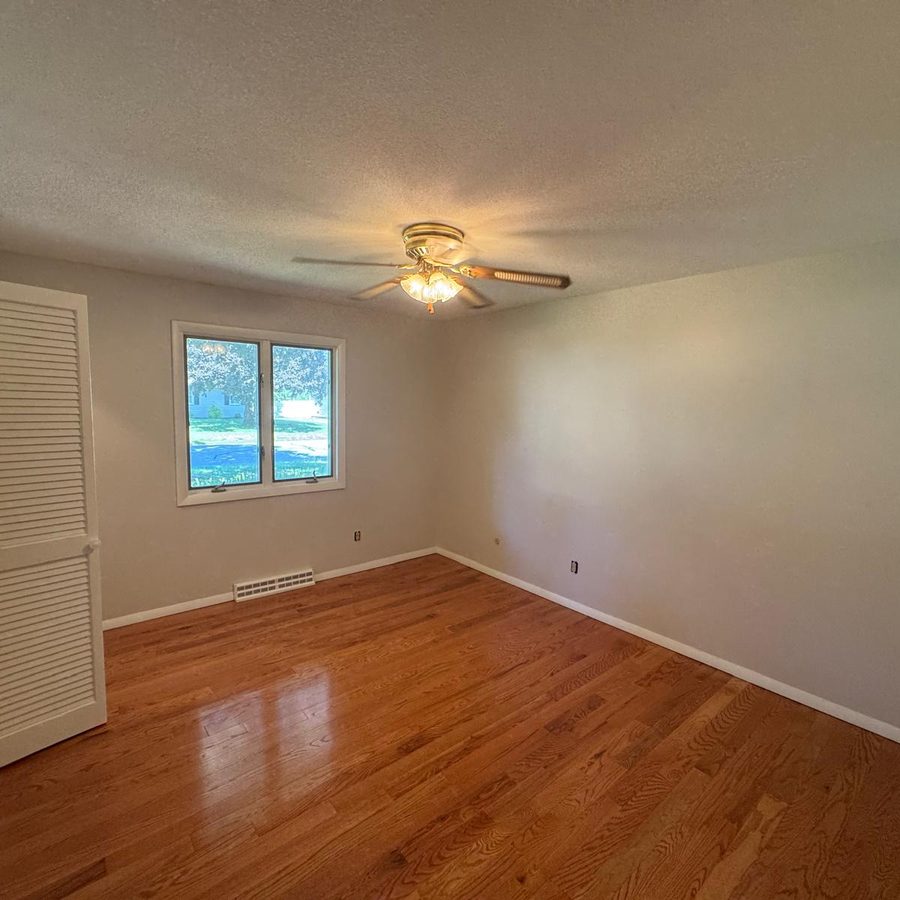 Bedroom with freshly painted neutral walls and white trim