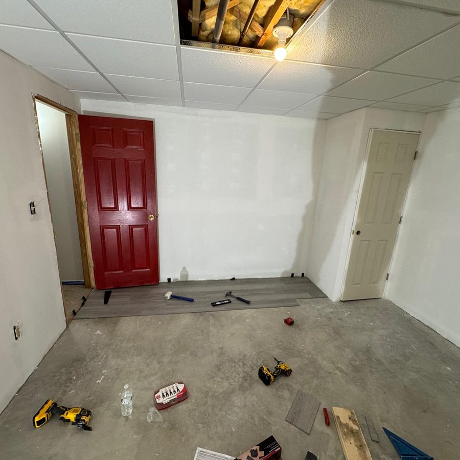 Finished basement room with smooth white walls and new doors