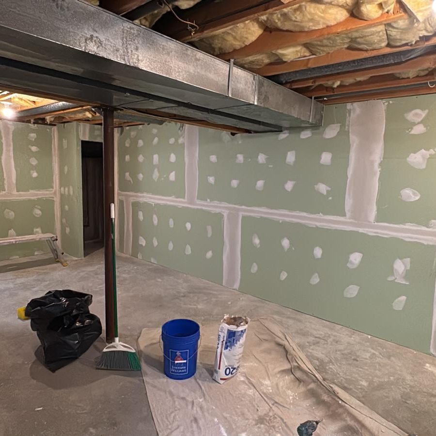 Basement drywall with taped and mudded seams and screw spots