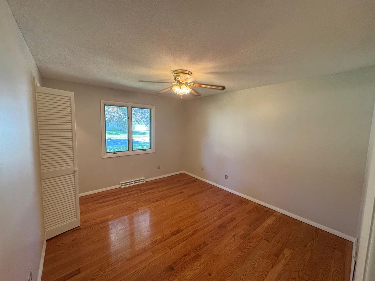 Bedroom with freshly painted neutral walls and white trim