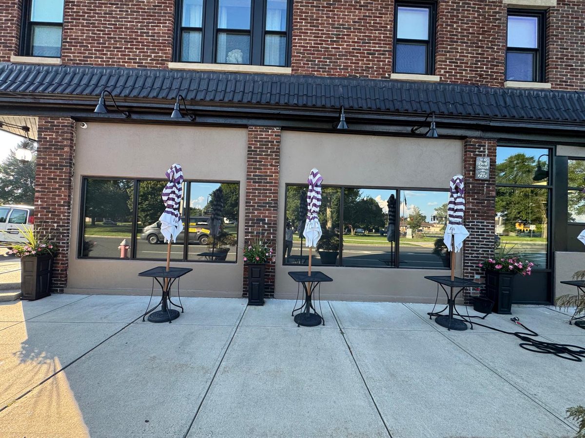 Brick storefront after exterior repaint of the stucco panels