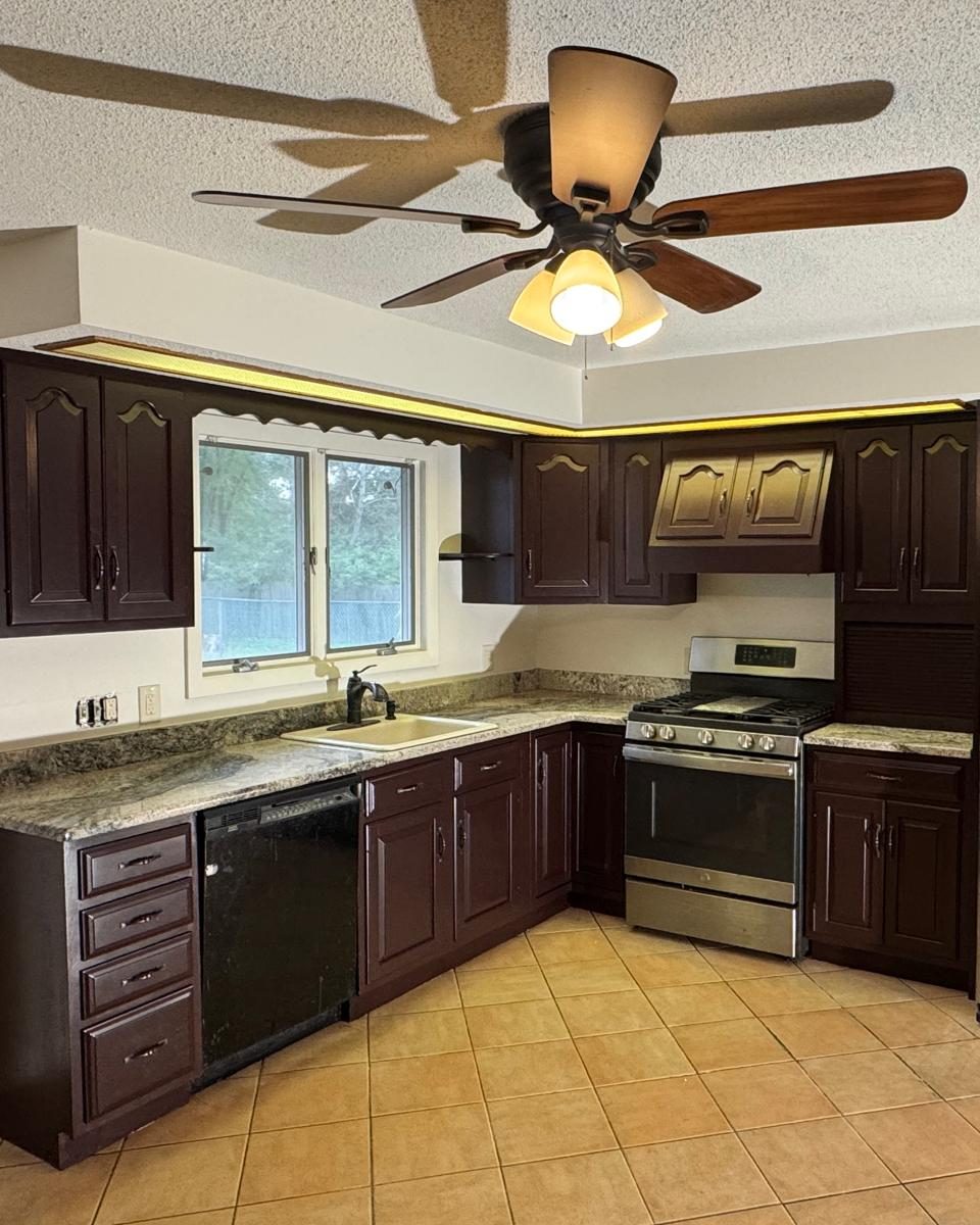 Kitchen after cabinet painting in a deep espresso finish