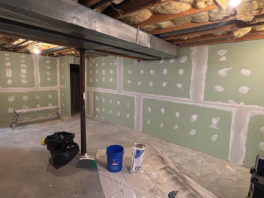 Basement drywall with taped and mudded seams and screw spots