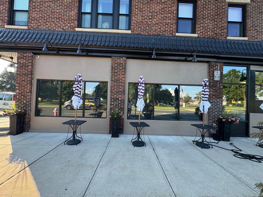 Brick storefront after exterior repaint of the stucco panels