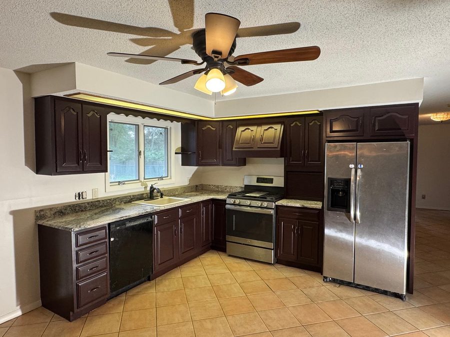 Kitchen after cabinet painting in a deep espresso finish