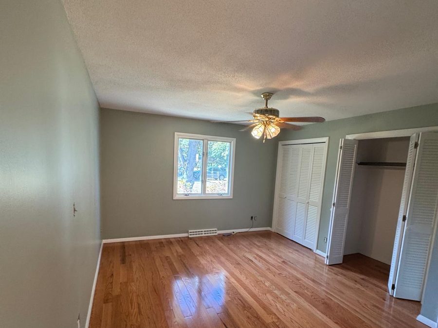 Finished bedroom with sage green walls and white trim