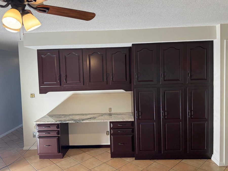 Kitchen desk and tall cabinets after painting in a deep espresso finish