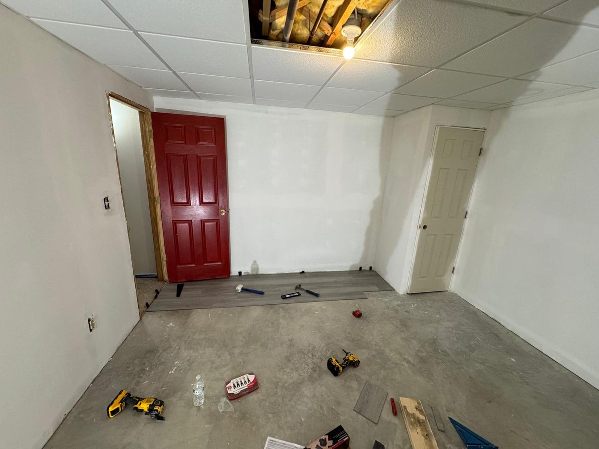 Finished basement room with smooth white walls and new doors