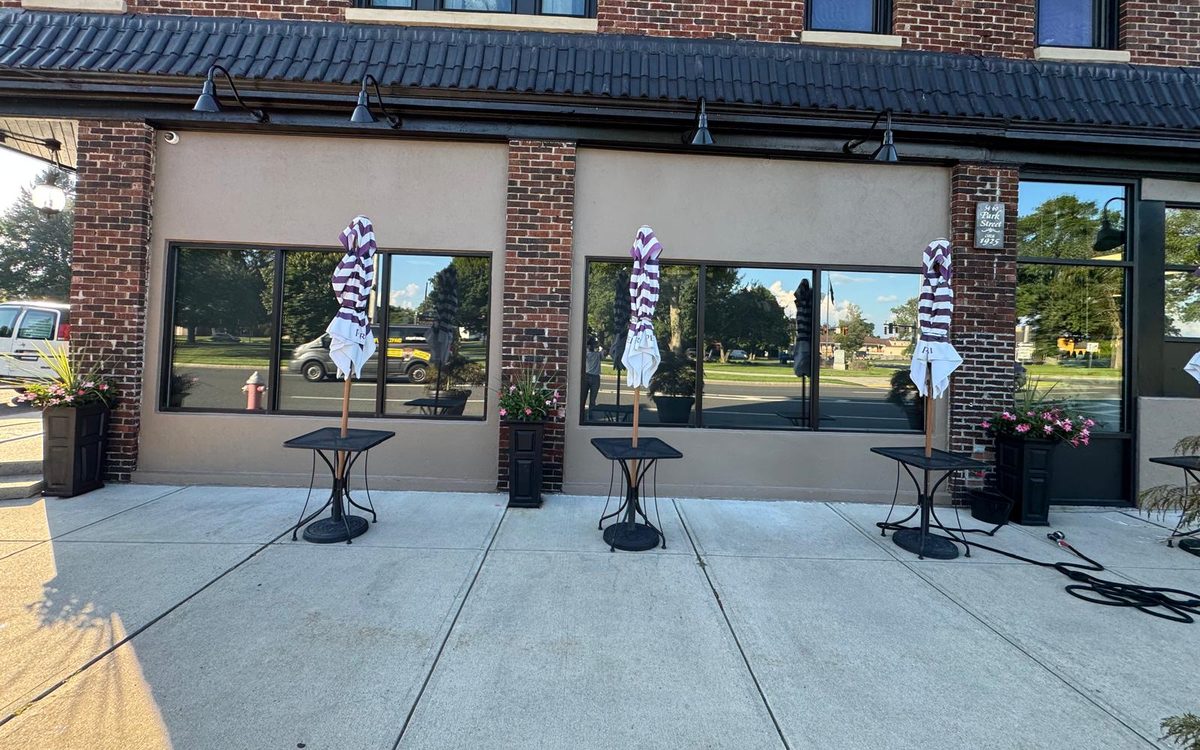 Brick storefront after exterior repaint of the stucco panels